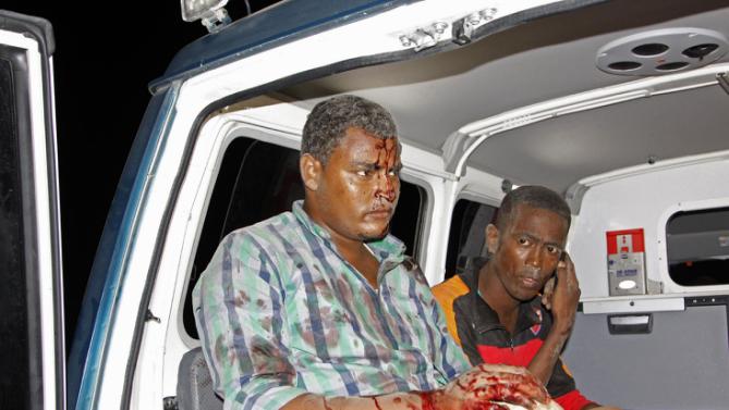 Somalis injured in a suicide car bomb attack on a hotel in Mogadishu, Somalia, Friday, Feb, 26 2016. A suicide bomber rammed his car into a hotel's entrance in Mogadishu and blew it up, allowing Al-Shabab gunmen to force their way into the hotel, exchanging fire with hotel guards and leaving 14 dead before government security forces ended the attack, including four gunmen and the suicide bomber. (AP Photo/Farah Abdi Warsameh)
